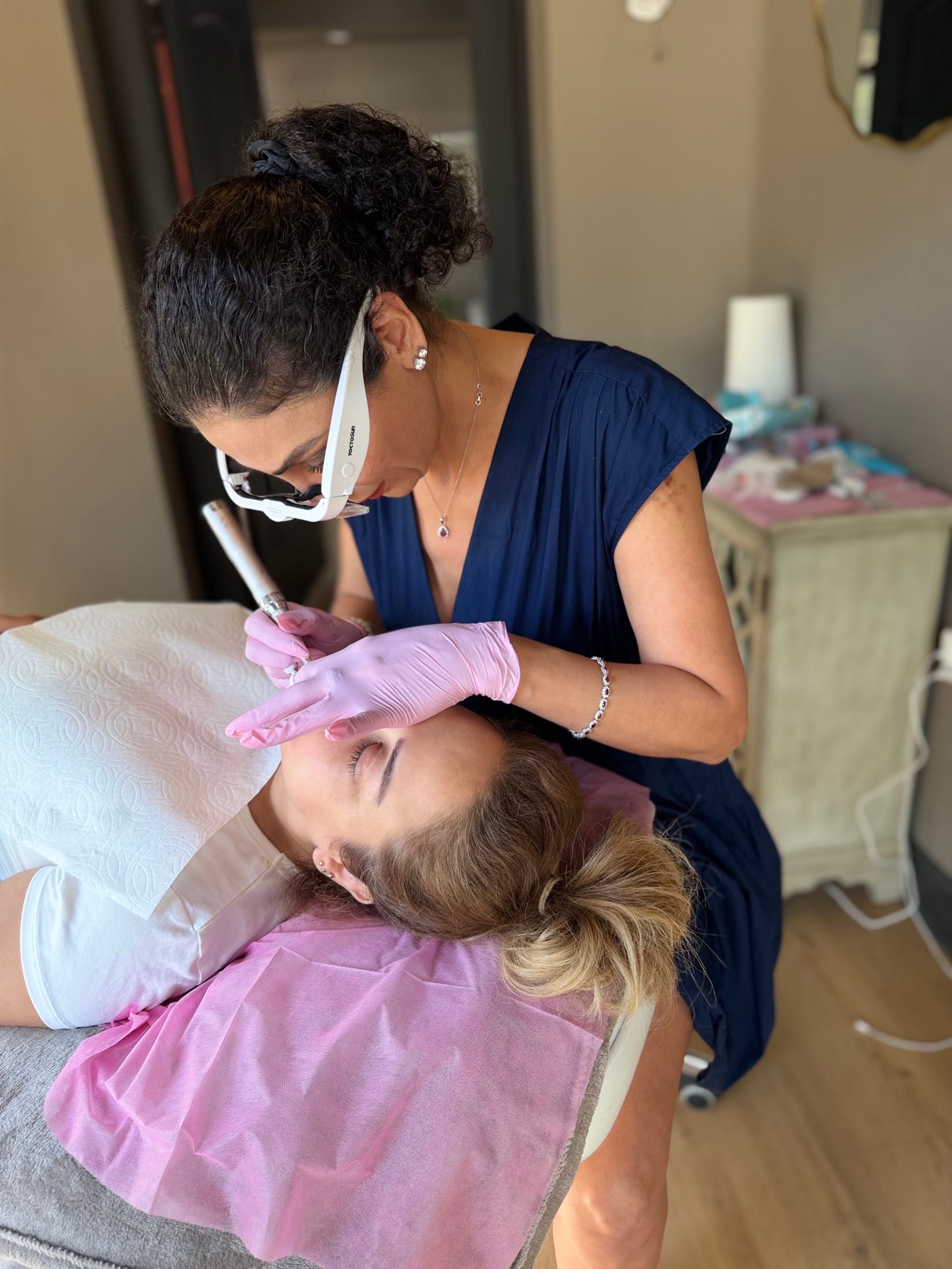 Soza performing a brow procedure with magnifying loupes in the BonBrow atelier
